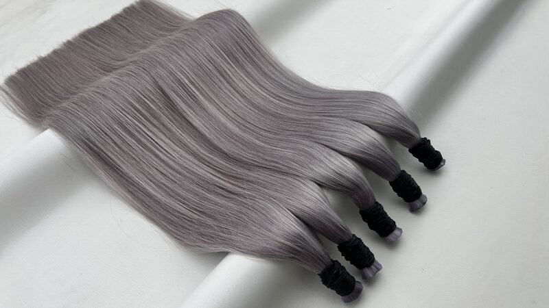 Bundles of straight bulk human hair in colour Grey on a plain background, with the bound ends visible at the base.