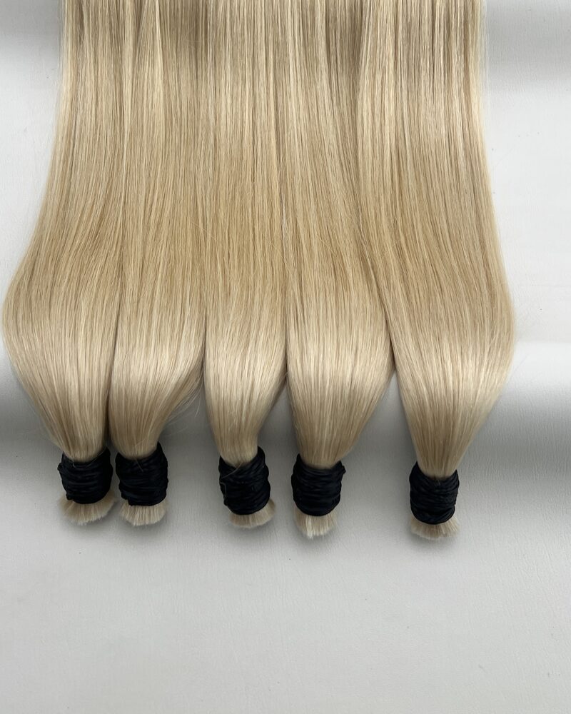 Bundles of straight bulk human hair in colour #14 on a plain background, the roots lying loose at the top and the ends bound at the base.
